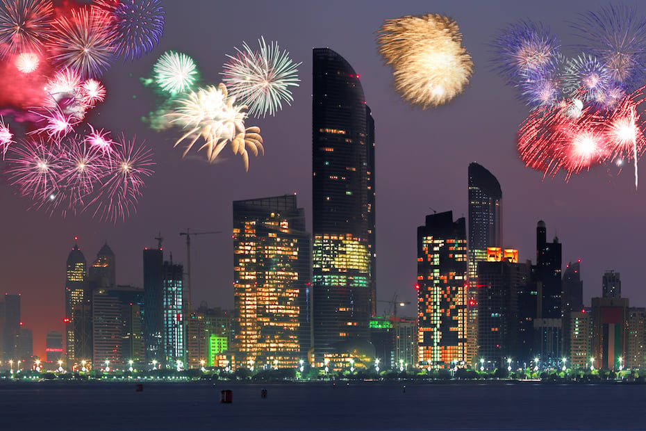 Abu Dhabi with skyscrapers against fireworks in UAE