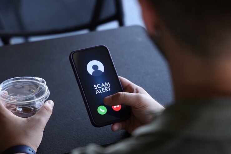 Scam alert on mobile phone screen