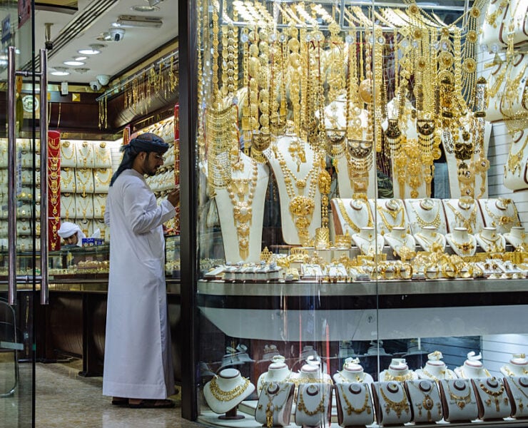 Gold dips as dollar firms, investors weigh US rate outlook