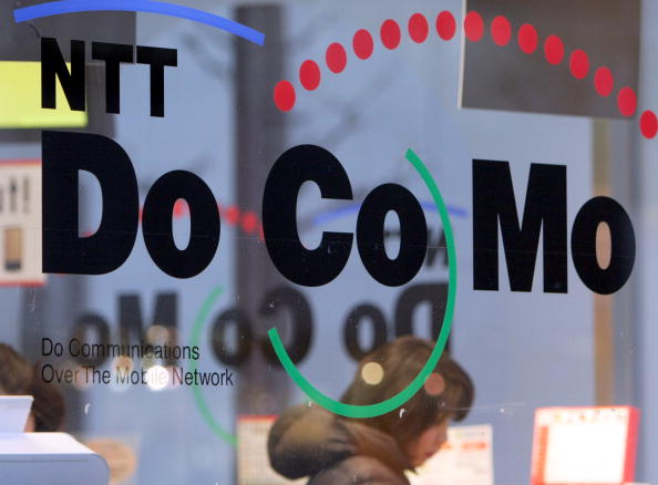 A woman looks at mobile products in a NTT DoCoMo Inc. shop i