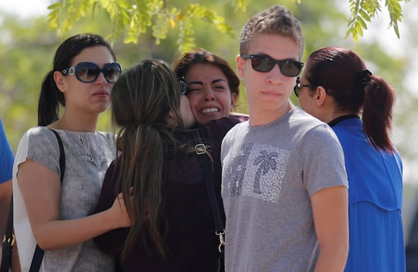 Unidentified relatives and friends of passengers who were flying in an EgyptAir plane wait outside the Egyptair in-flight service building in Cairo
