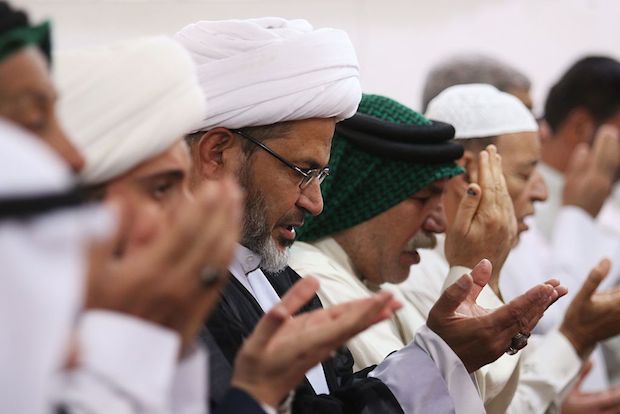 Muslim devotees perform the morning Eid al-Adha prayer at a mosque in the Iraqi city of Basra.