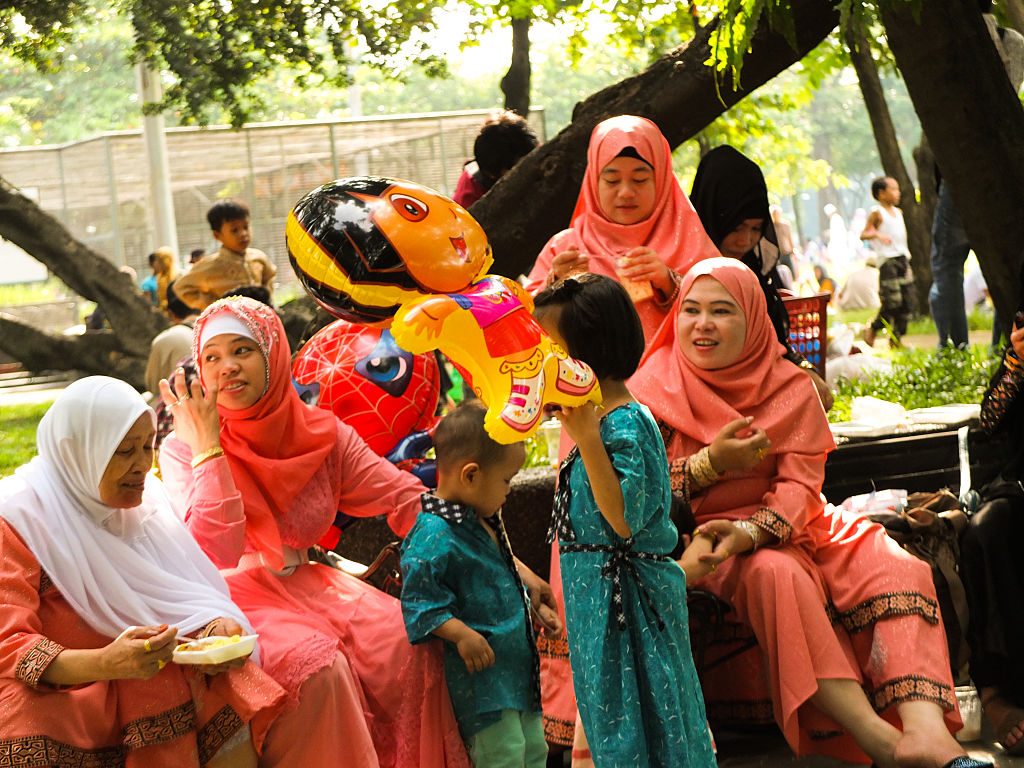 Muslim women with the same colors of Hijab, exchange conversations during the Eid Al Adha celebrations in Quirino Grandstand grounds in the Philippines.